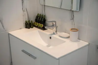 a bathroom with a sink and a mirror at Bright 2BR apartment in Palaio Faliro-(FAL_A1) in Athens