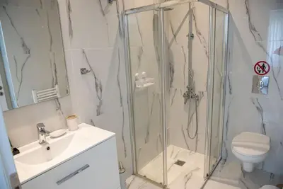 a bathroom with a shower and a sink and a toilet at Bright 2BR apartment in Palaio Faliro-(FAL_A1) in Athens