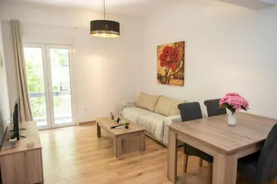 a living room with a couch and a table at Renovated spacious flat 7min to subway station-(ΝIK_A) in Athens