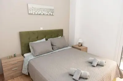 a bedroom with a bed with two towels on it at Renovated spacious flat 7min to subway station-(ΝIK_A) in Athens