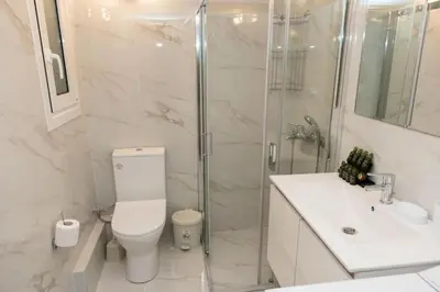 a bathroom with a shower and a toilet and a sink at Renovated spacious flat 7min to subway station-(ΝIK_A) in Athens