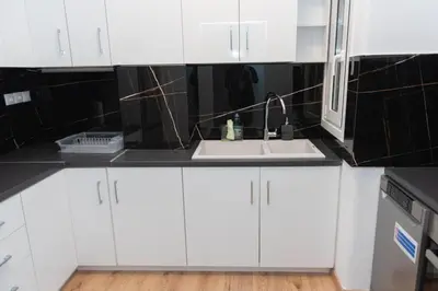 a kitchen with white cabinets and a sink at Renovated spacious flat 7min to subway station-(ΝIK_A) in Athens