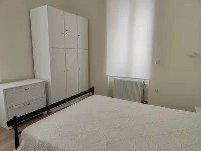a bedroom with a bed and a white cabinet at Litseli in Athens