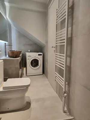 a bathroom with a toilet and a washing machine at Litseli in Athens