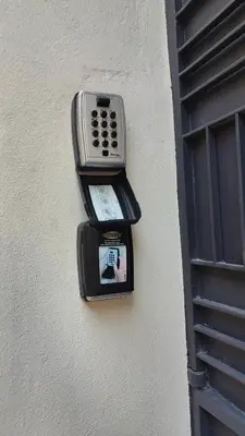 a cell phone on the side of a building at Litseli in Athens
