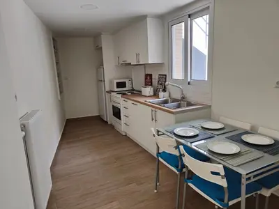 a kitchen with a table and chairs and a sink at Litseli in Athens