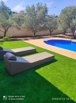 a yard with a pool and green grass at Villa Lagonisi in Aghia Marina