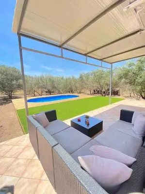 a patio with a couch and a table on a patio at Villa Lagonisi in Aghia Marina