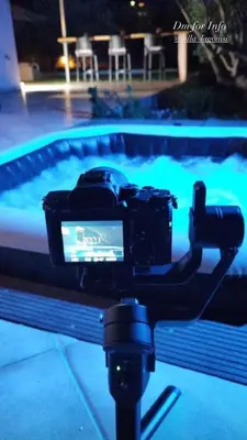 a camera in front of a swimming pool at night at Villa Lagonisi in Aghia Marina