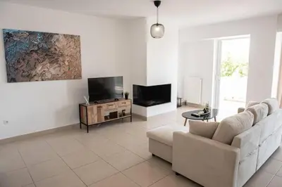 a living room with a couch and a tv at Overlooking park flat close to the Piraeus Port-(DRAP-A7) in Piraeus