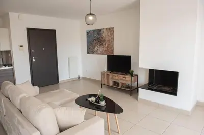 a living room with a white couch and a table at Overlooking park flat close to the Piraeus Port-(DRAP-A7) in Piraeus