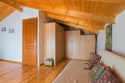 a living room with a couch and a wooden ceiling at Sea Breeze Garden Maisonette - Porto Rafti by ΜΡS in Porto Rafti