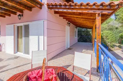 a patio with two chairs and a table on a porch at Sea Breeze Garden Maisonette - Porto Rafti by ΜΡS in Porto Rafti