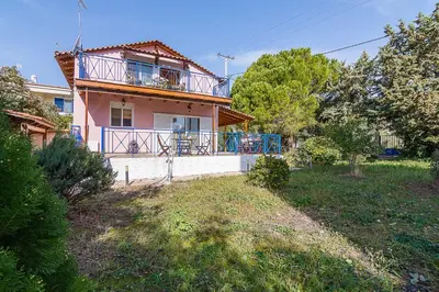 a house with a balcony on top of it at Sea Breeze Garden Maisonette - Porto Rafti by ΜΡS in Porto Rafti