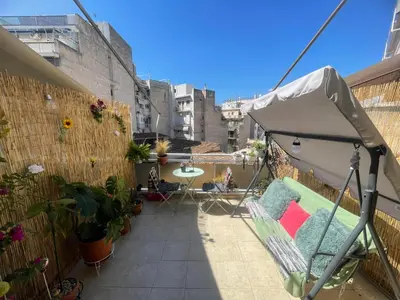 a balcony with a tent and a table and chairs at Sunny Studio in Athens
