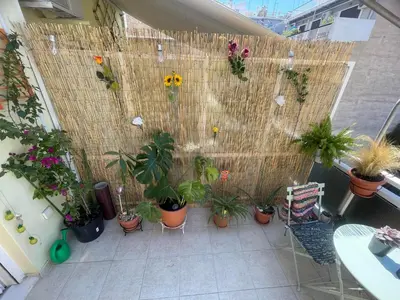 a balcony with a bunch of potted plants at Sunny Studio in Athens