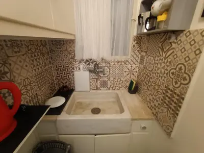 a small kitchen with a sink in the corner at Sunny Studio in Athens