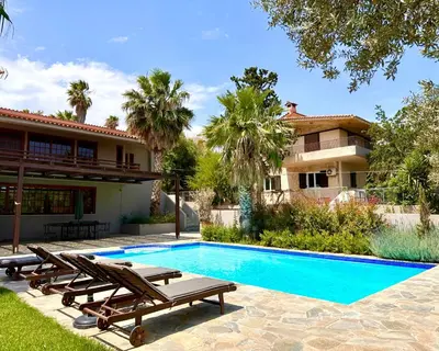a villa with a swimming pool and a house at George's gorgeous house Anavysos in Anavissos