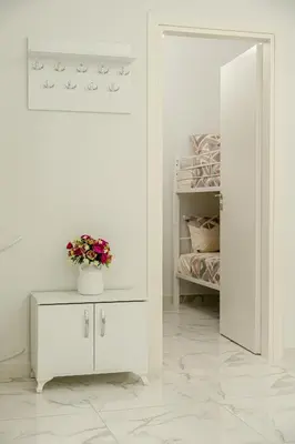 a bedroom with a bed and a white cabinet with a potted plant at Athenian Destiny Suite in Athens