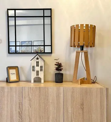 a mirror on top of a wooden dresser with a lamp at Dafni City Apartment 1 in Athens