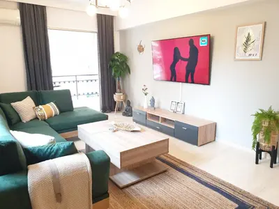 a living room with a couch and a coffee table at EcoStay-Scandy,2bdr cozy apartment by the sea in Alimos in Athens