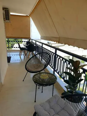 a balcony with chairs and tables on a roof at EcoStay-Scandy,2bdr cozy apartment by the sea in Alimos in Athens