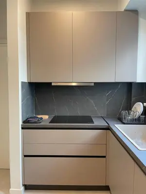a kitchen with white cabinets and a counter top at Sapfo Luxury Apartment 1 in Athens in Athens