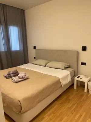 a bedroom with a bed with two towels on it at Sapfo Luxury Apartment 1 in Athens in Athens
