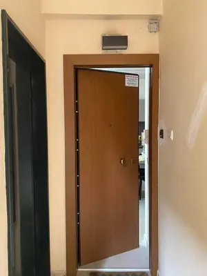 a door in a room with a sign on the wall at Sapfo Luxury Apartment 1 in Athens in Athens