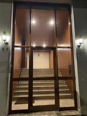 a large glass door with stairs in a building at Sapfo Luxury Apartment 1 in Athens in Athens