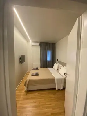 a hotel room with a bed and a window at Sapfo Luxury Apartment 1 in Athens in Athens