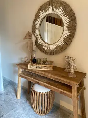 a mirror on the wall above a wooden table at Aelia Houses2 in Agia Marina Aegina