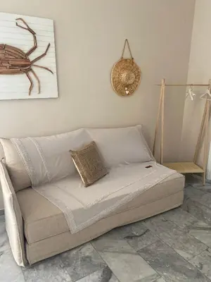 a white couch in a living room with at Aelia Houses2 in Agia Marina Aegina