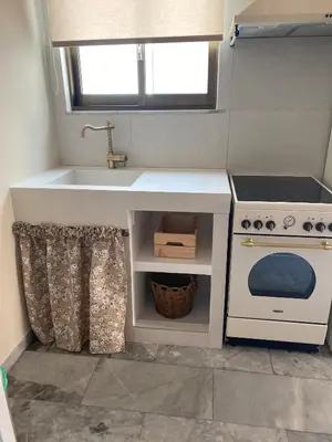 a kitchen with a sink and a stove at Aelia Houses2 in Agia Marina Aegina
