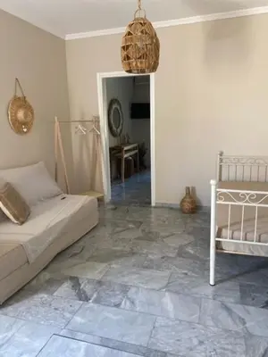 a bedroom with a bed and a room with a tile floor at Aelia Houses2 in Agia Marina Aegina