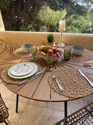 a wooden table with a plate of fruit on it at Aelia Houses2 in Agia Marina Aegina