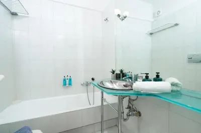 a bathroom with a sink and a bath tub at Phos Apartment by A&D Properties in Porto Rafti