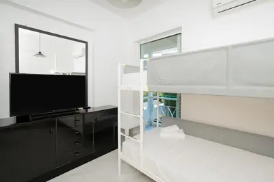 a bedroom with a bunk bed and a flat screen tv at Phos Apartment by A&D Properties in Porto Rafti