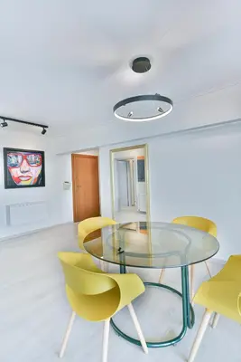 a dining room with a glass table and yellow chairs at Milano Lux in Athens