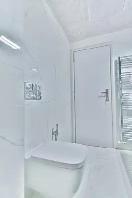 a white bathroom with a toilet and a sink at Milano Lux in Athens