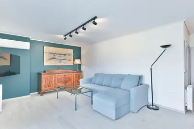 a living room with a blue couch and a table at Milano Lux in Athens