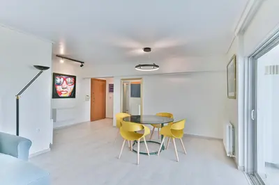 a dining room with a table and yellow chairs at Milano Lux in Athens