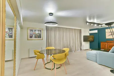 a living room with a table and chairs and a couch at Milano Lux in Athens