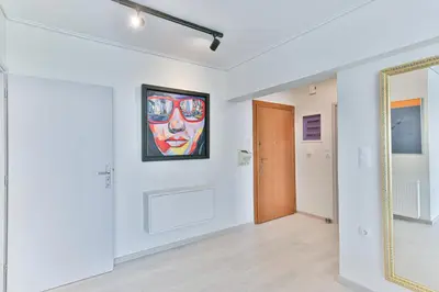 an empty room with a painting on the wall and a mirror at Milano Lux in Athens