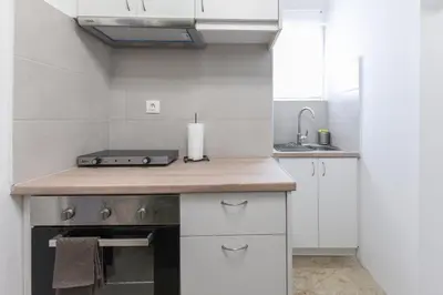 a kitchen with a counter with a candle on it at Sweet & New Studio-Center Athens in Athens