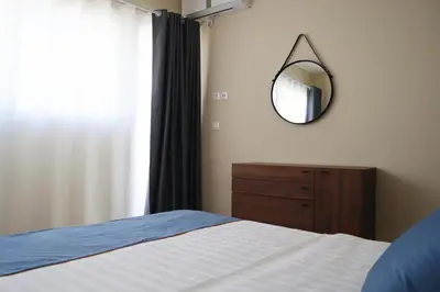 a bedroom with a bed with a mirror and a dresser at Dafni City Apartment 2 in Athens