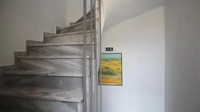 a staircase in a room with a painting on the wall at Dafni City Apartment 2 in Athens