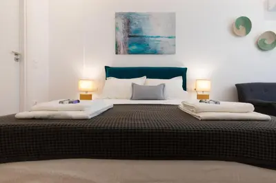 a bedroom with a large bed with two pillows on it at Minimal apartment in Plaka in Athens