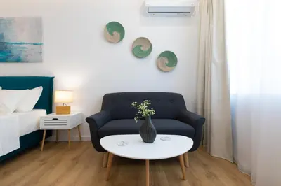 a living room with a couch and a vase on a table at Minimal apartment in Plaka in Athens