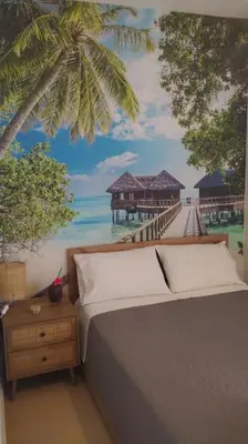 a bedroom with a bed with a mural of a pier at The Artemis House Project in Artemida